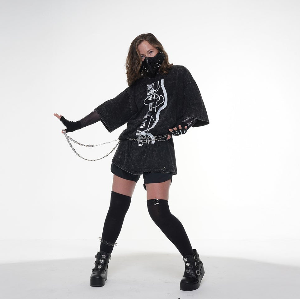 Model wearing a black K-pop outfit with a graphic design on a white background